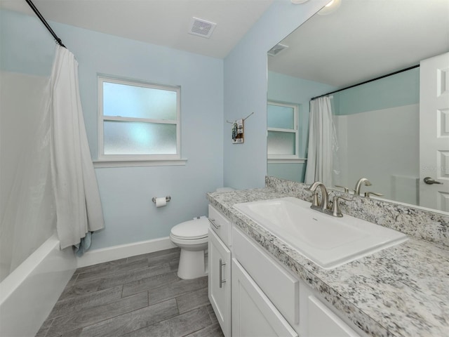 460 Bard Rd, Venice, FL 34293 - full bathroom with vanity, toilet, baseboards, shower / bath combination with curtain, and wood tiled floors