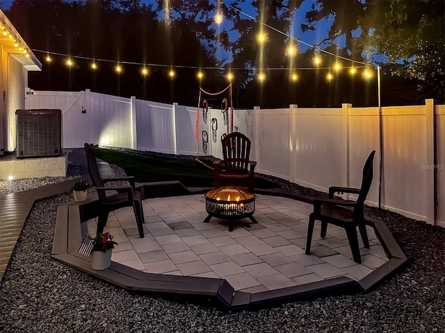 460 Bard Rd, Venice, FL 34293 - patio at twilight featuring an outdoor fire pit, a patio area, a fenced backyard, and central AC