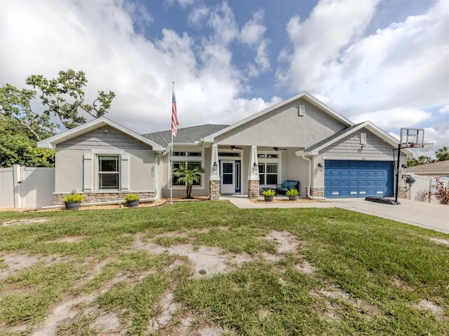 460 Bard Rd, Venice, FL 34293 - view of front of house with stucco siding, driveway, a garage, stone siding, and a porch