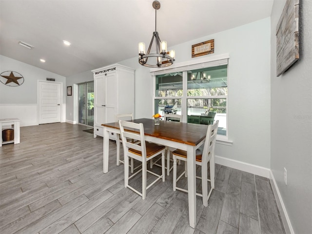 460 Bard Rd, Venice, FL 34293 - dining space with a chandelier, wood finished floors, baseboards, vaulted ceiling, and recessed lighting