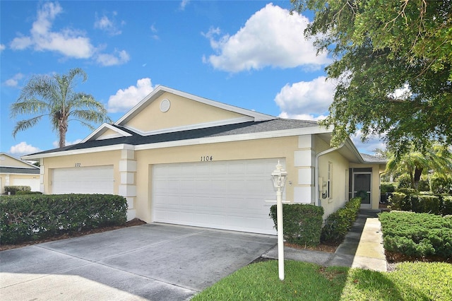 1104 Auburn Cove Cir, Venice, FL 34292 - single story home with stucco siding, a garage, and concrete driveway