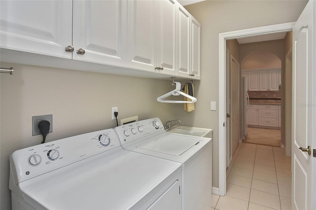 1104 Auburn Cove Cir, Venice, FL 34292 - washroom featuring light tile patterned floors, cabinet space, independent washer and dryer, and baseboards