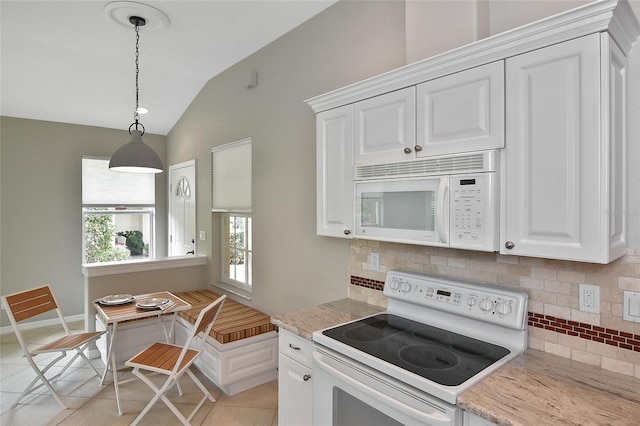 1104 Auburn Cove Cir, Venice, FL 34292 - kitchen featuring white appliances, backsplash, vaulted ceiling, and white cabinetry