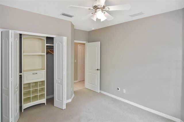 1104 Auburn Cove Cir, Venice, FL 34292 - unfurnished bedroom with light carpet, a closet, baseboards, and a ceiling fan