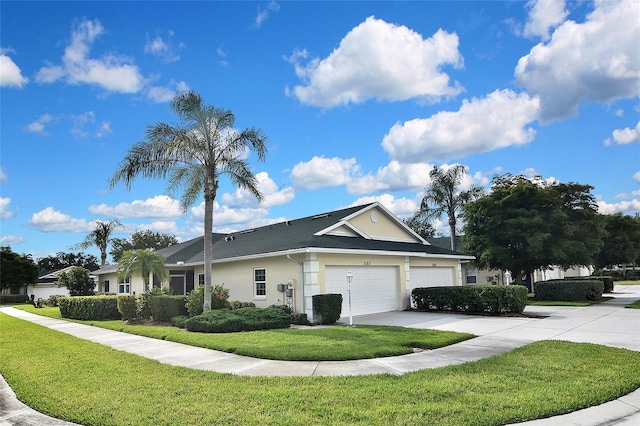 1104 Auburn Cove Cir, Venice, FL 34292 - view of property exterior with stucco siding, driveway, a yard, and a garage