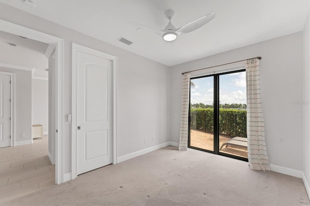 209 E Venice Ave, Venice, FL 34285 - unfurnished bedroom featuring access to outside, baseboards, carpet flooring, and ceiling fan