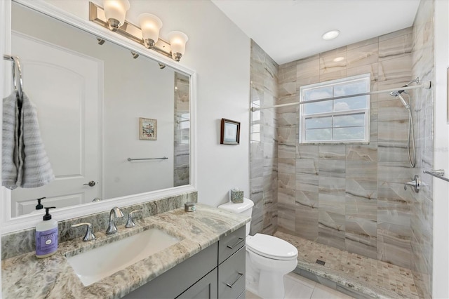 209 E Venice Ave, Venice, FL 34285 - bathroom with vanity, toilet, tiled shower, and tile patterned flooring