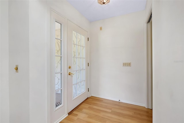 915 S Doral Ln, Venice, FL 34293 - doorway with light wood-type flooring, baseboards, and healthy amount of natural light
