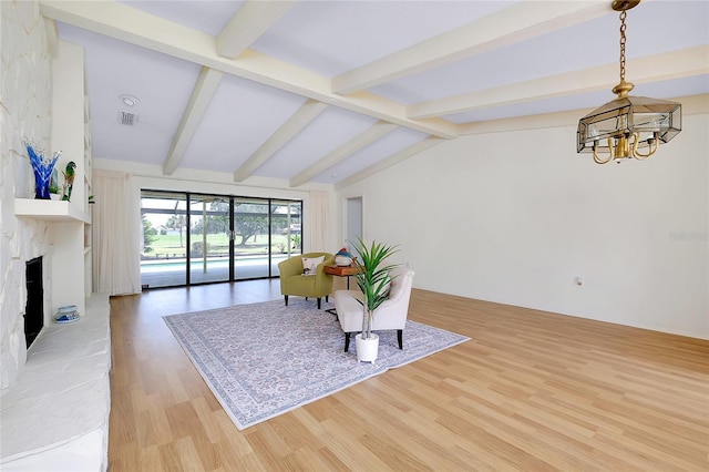 915 S Doral Ln, Venice, FL 34293 - living area featuring a chandelier, light wood-type flooring, and a fireplace