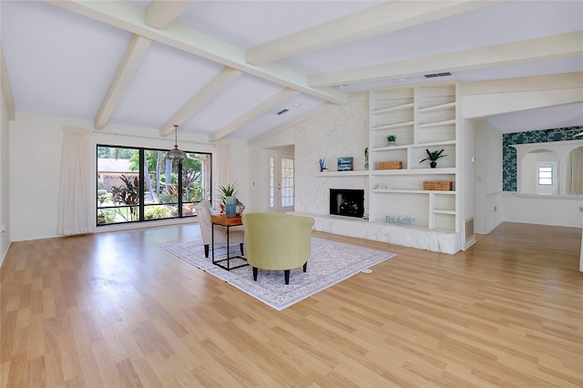 915 S Doral Ln, Venice, FL 34293 - living room with light wood-style floors, a large fireplace, and baseboards
