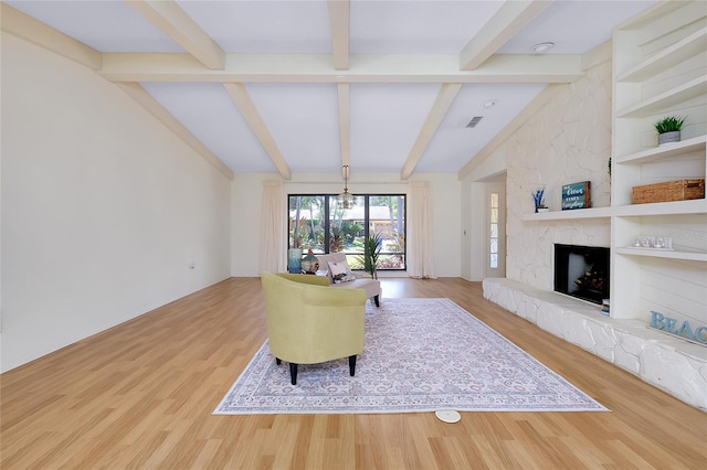 915 S Doral Ln, Venice, FL 34293 - living room featuring wood finished floors, a fireplace, and a chandelier