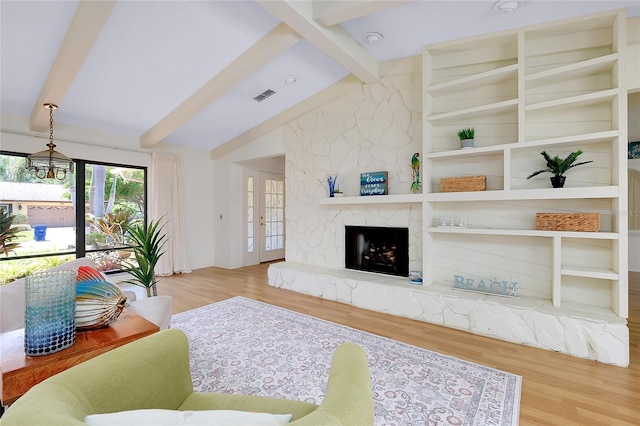 915 S Doral Ln, Venice, FL 34293 - living room featuring wood finished floors and a fireplace