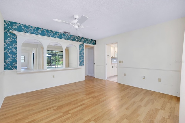 915 S Doral Ln, Venice, FL 34293 - unfurnished room featuring wood finished floors, a ceiling fan, and a textured ceiling