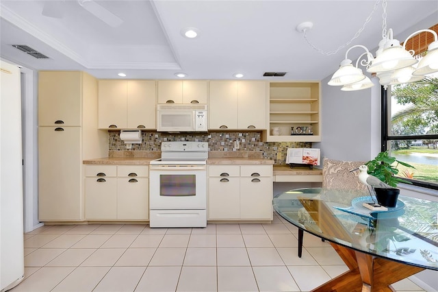 915 S Doral Ln, Venice, FL 34293 - kitchen featuring white appliances, cream cabinets, light countertops, decorative backsplash, and a tray ceiling