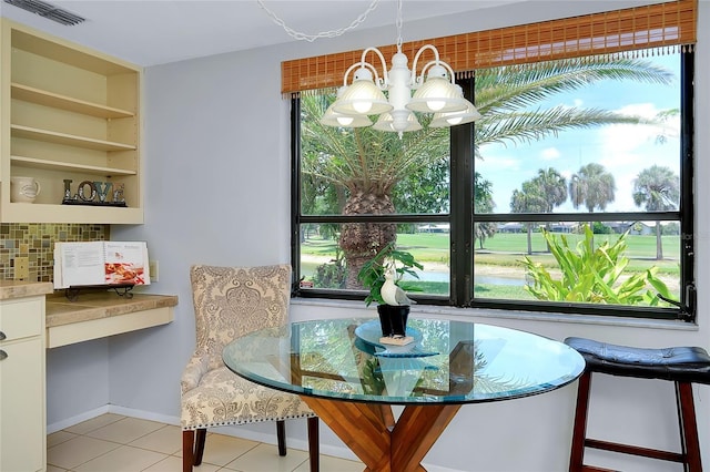 915 S Doral Ln, Venice, FL 34293 - dining area with a chandelier, light tile patterned floors, and baseboards