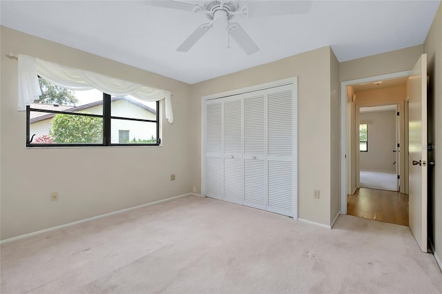 915 S Doral Ln, Venice, FL 34293 - unfurnished bedroom with light carpet, a closet, baseboards, and a ceiling fan