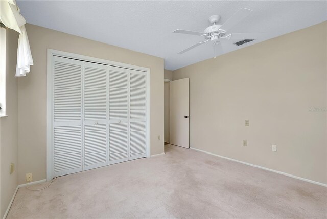 915 S Doral Ln, Venice, FL 34293 - unfurnished bedroom with light carpet, a closet, baseboards, and ceiling fan