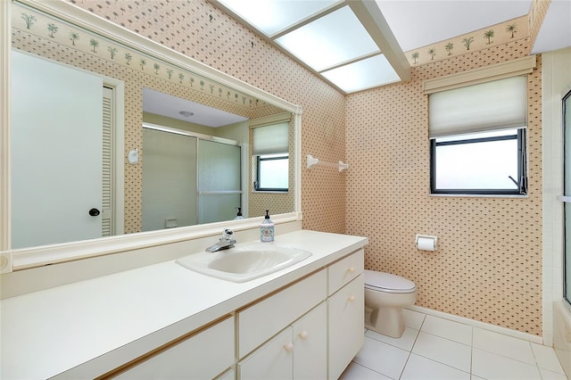 915 S Doral Ln, Venice, FL 34293 - full bath featuring toilet, a shower with door, tile patterned flooring, vanity, and wallpapered walls