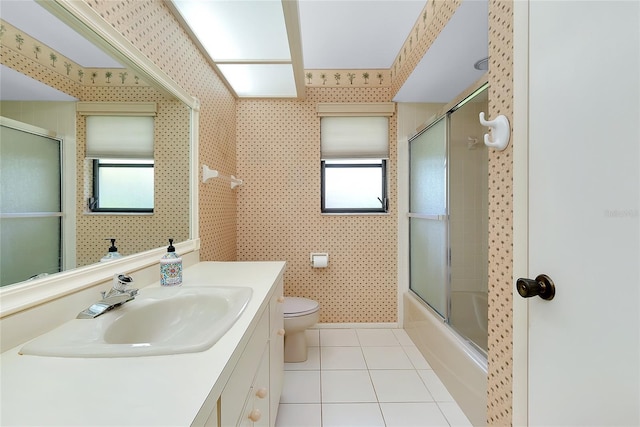 915 S Doral Ln, Venice, FL 34293 - bathroom with tile patterned flooring, toilet, vanity, shower / bath combination with glass door, and wallpapered walls