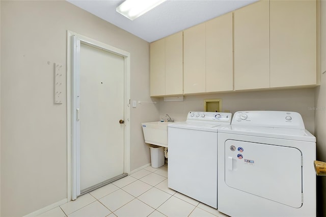 915 S Doral Ln, Venice, FL 34293 - laundry area with cabinet space, washer and dryer, baseboards, and light tile patterned floors