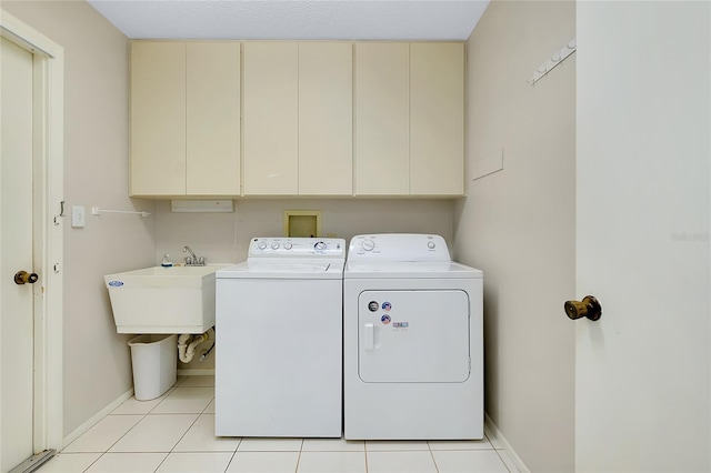 915 S Doral Ln, Venice, FL 34293 - laundry room with cabinet space, separate washer and dryer, baseboards, and light tile patterned flooring
