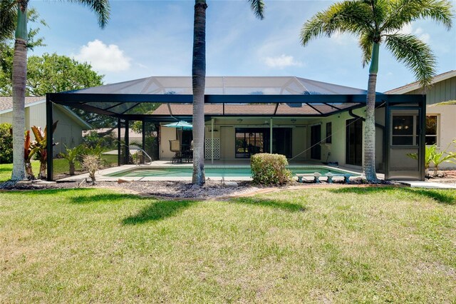915 S Doral Ln, Venice, FL 34293 - rear view of house with a lawn, glass enclosure, an outdoor pool, and a patio area