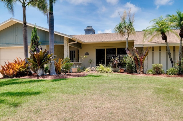 915 S Doral Ln, Venice, FL 34293 - ranch-style home with a garage, a front lawn, a chimney, stucco siding, and roof with shingles