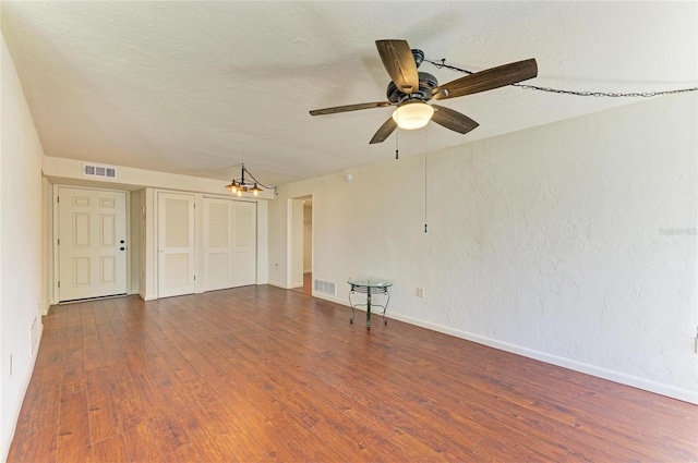 618 Bird Bay Dr S Unit 110, Venice, FL 34285 - spare room with baseboards, wood finished floors, ceiling fan, and a chandelier