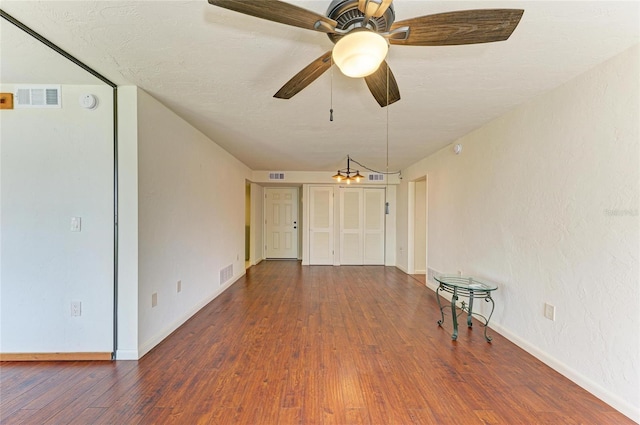 618 Bird Bay Dr S Unit 110, Venice, FL 34285 - empty room featuring wood finished floors, baseboards, a ceiling fan, and a chandelier
