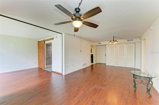 618 Bird Bay Dr S Unit 110, Venice, FL 34285 - unfurnished living room featuring ceiling fan, wood finished floors, and baseboards