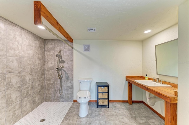 618 Bird Bay Dr S Unit 110, Venice, FL 34285 - bathroom with tiled shower, toilet, baseboards, a sink, and recessed lighting