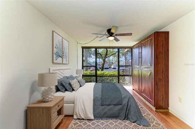 618 Bird Bay Dr S Unit 110, Venice, FL 34285 - bedroom with light wood-style floors and ceiling fan