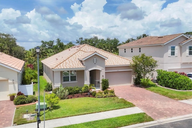 2034 Mesic Hammock Way, Venice, FL 34292 - mediterranean / spanish house with decorative driveway, a tiled roof, stucco siding, and an attached garage