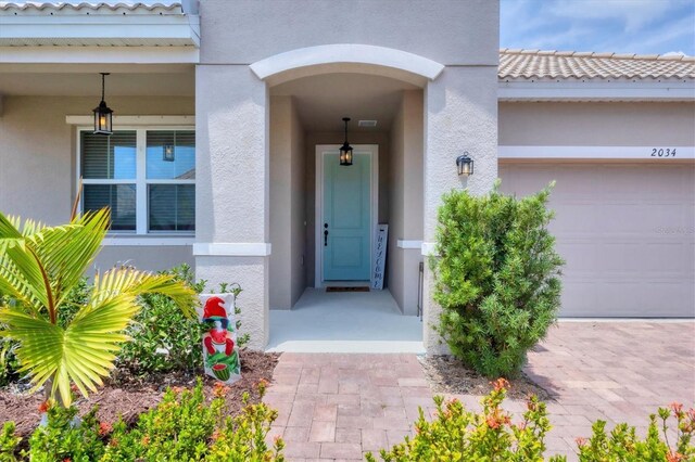 2034 Mesic Hammock Way, Venice, FL 34292 - property entrance featuring stucco siding and a garage