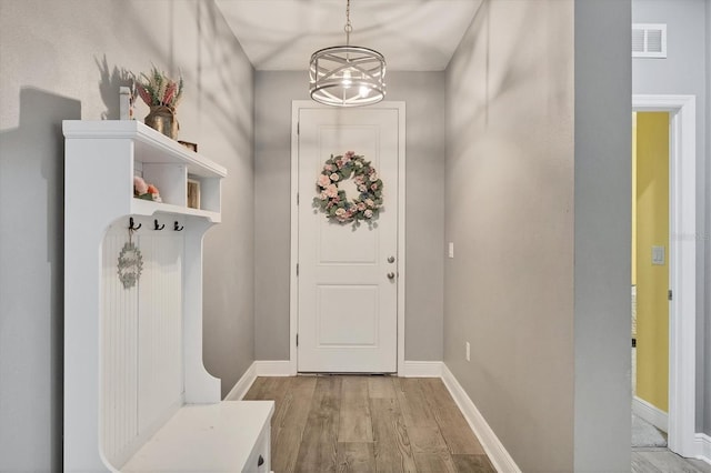 2034 Mesic Hammock Way, Venice, FL 34292 - mudroom featuring light wood-type flooring, a chandelier, and baseboards