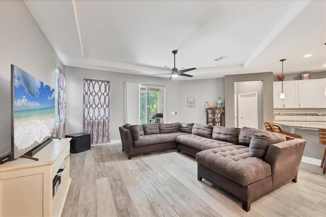 2034 Mesic Hammock Way, Venice, FL 34292 - living area with a tray ceiling, a ceiling fan, light wood-type flooring, recessed lighting, and baseboards
