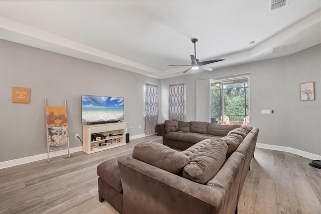 2034 Mesic Hammock Way, Venice, FL 34292 - living area featuring a tray ceiling, ceiling fan, light wood-style floors, and baseboards