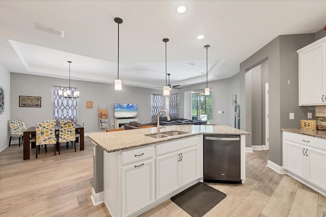 2034 Mesic Hammock Way, Venice, FL 34292 - kitchen with a sink, stainless steel dishwasher, a tray ceiling, light wood-type flooring, and recessed lighting