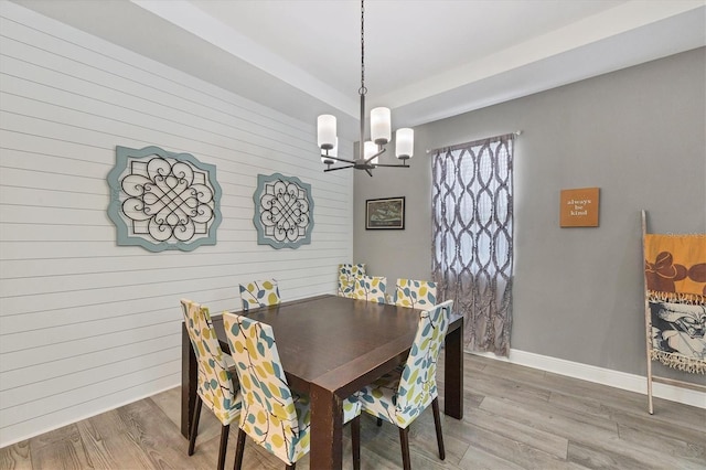 2034 Mesic Hammock Way, Venice, FL 34292 - dining room with a chandelier, light wood-type flooring, wood walls, and baseboards