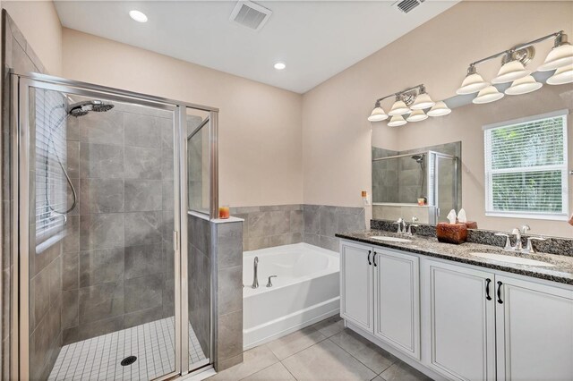 2034 Mesic Hammock Way, Venice, FL 34292 - full bathroom featuring tile patterned floors, a stall shower, a bath, double vanity, and recessed lighting