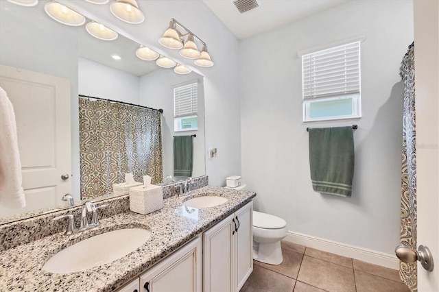 2034 Mesic Hammock Way, Venice, FL 34292 - bathroom featuring toilet, double vanity, tile patterned flooring, baseboards, and a shower with curtain