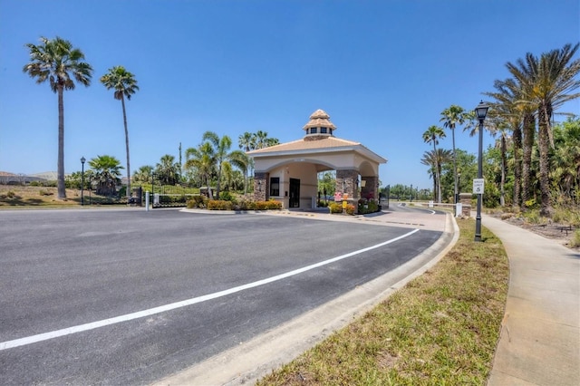 2034 Mesic Hammock Way, Venice, FL 34292 - view of asphalt street featuring street lighting, curbs, and a gated entry