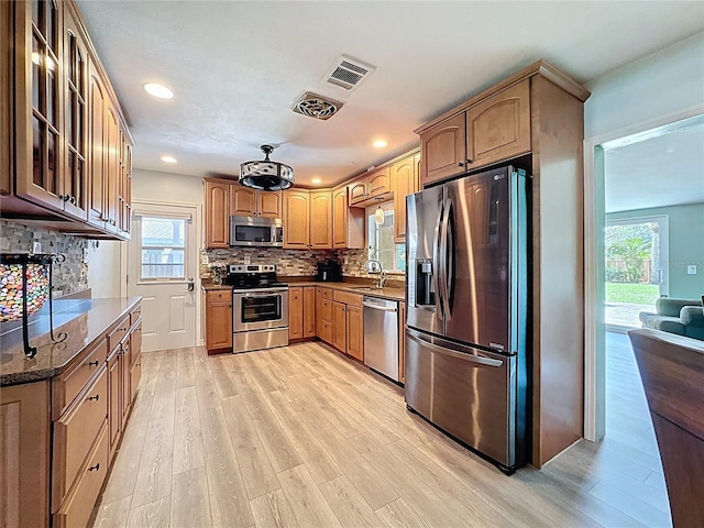 413 Valencia Rd, Venice, FL 34285 - kitchen with stainless steel appliances, a sink, light wood-style floors, plenty of natural light, and recessed lighting