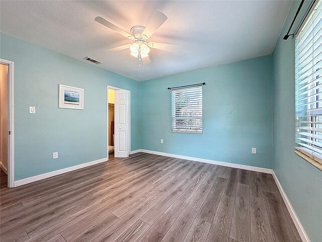 413 Valencia Rd, Venice, FL 34285 - spare room with dark wood-style floors, a ceiling fan, and baseboards