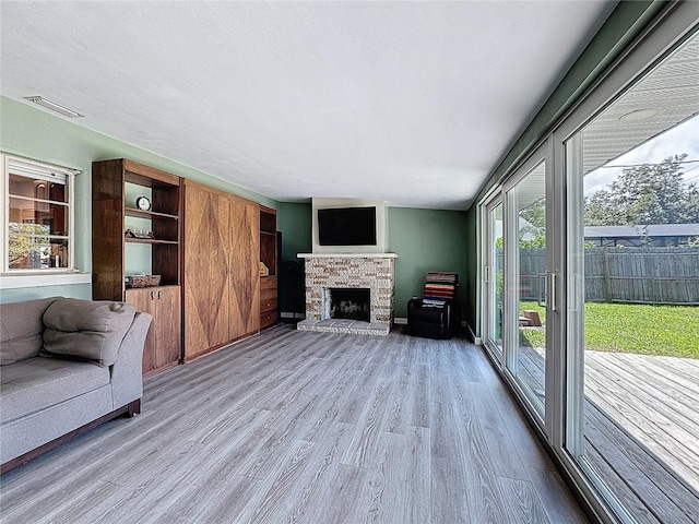 413 Valencia Rd, Venice, FL 34285 - living room with wood finished floors and a stone fireplace