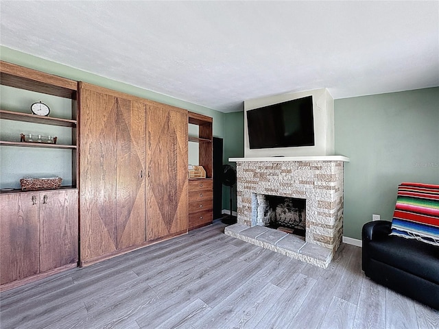 413 Valencia Rd, Venice, FL 34285 - unfurnished living room featuring wood finished floors, a fireplace, and baseboards