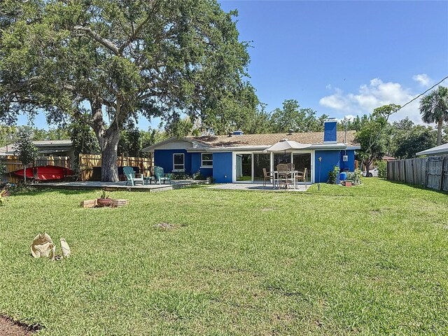 413 Valencia Rd, Venice, FL 34285 - back of property with a patio and a chimney