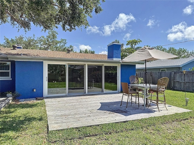 413 Valencia Rd, Venice, FL 34285 - rear view of house featuring a wooden deck, stucco siding, and a chimney