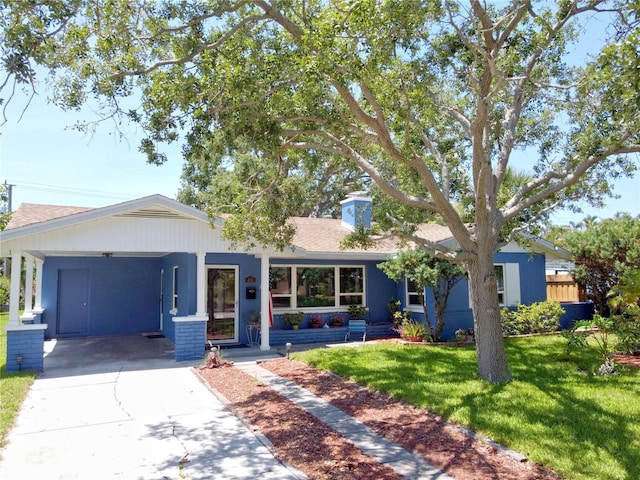413 Valencia Rd, Venice, FL 34285 - view of front facade featuring a front yard, an attached carport, concrete driveway, and a shingled roof