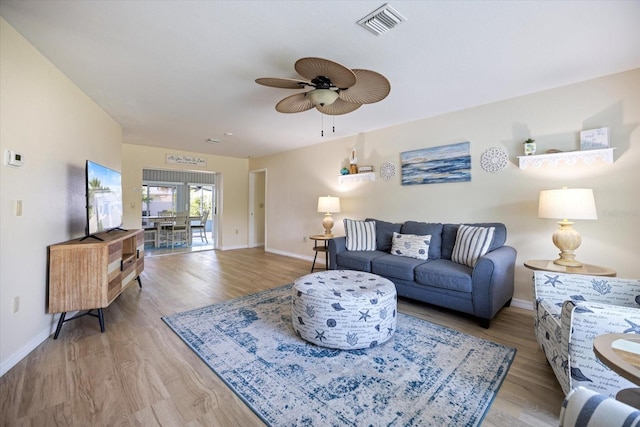 9277 Saint Catherine Ave, Englewood, FL 34224 - living room with light wood finished floors, ceiling fan, and baseboards